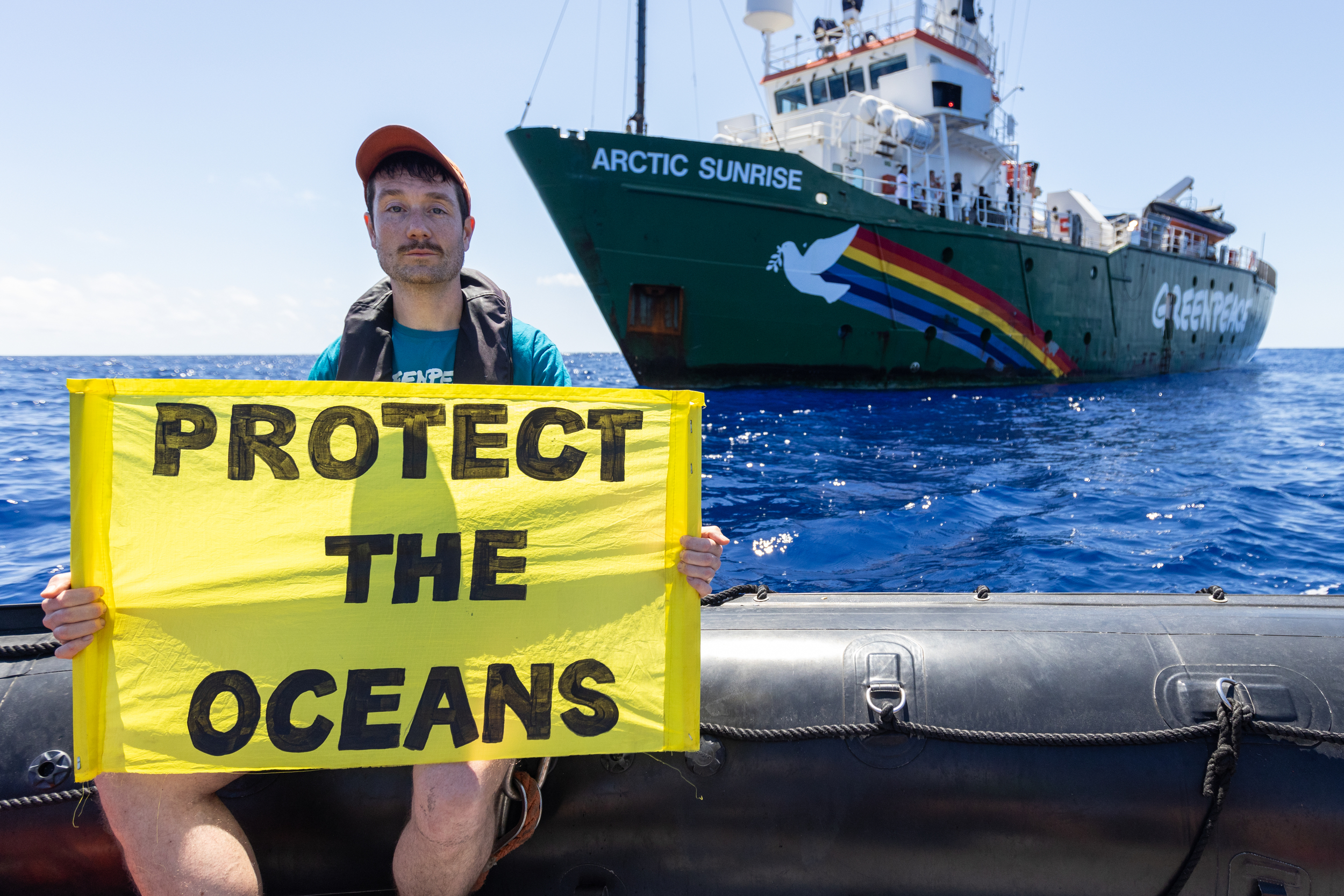 Dan from Bastille holding a protect the oceans banner