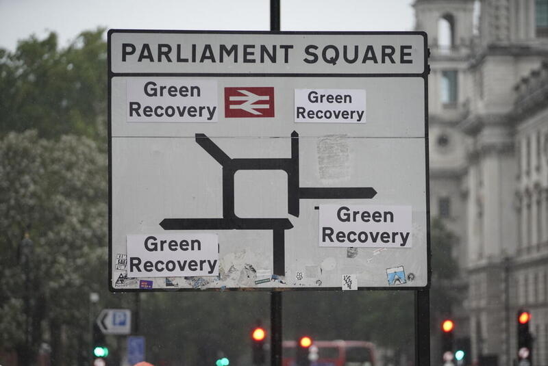 A road sign on Parliament Square showing all roads leading to a Green Recovery